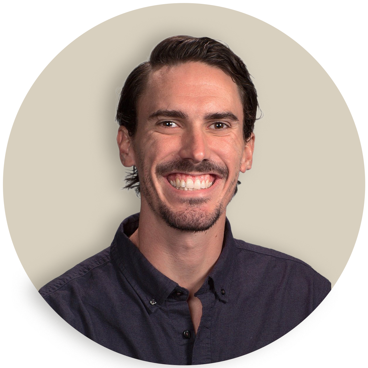 Portrait of Caleb Brown with dark hair and a mustache against a plain background