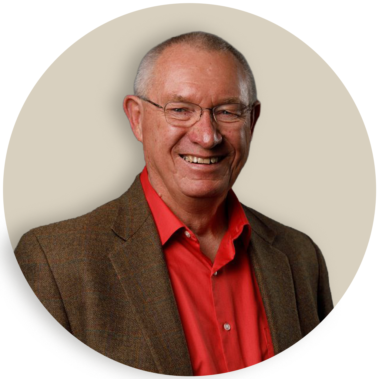 Portrait of Chuck Sackett wearing glasses, a red shirt, and a brown blazer