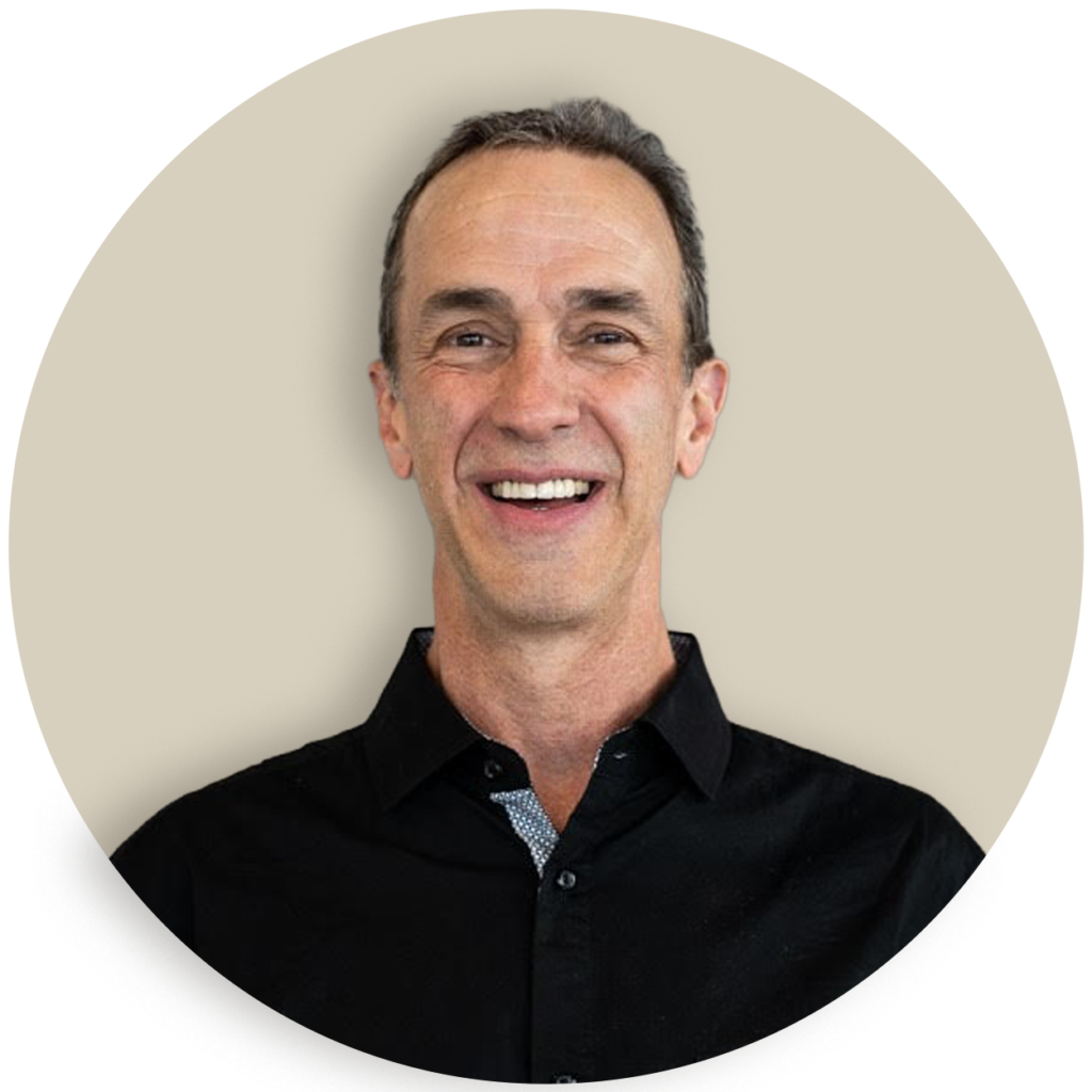 Portrait of Derek Voorhees in a black shirt on a beige background