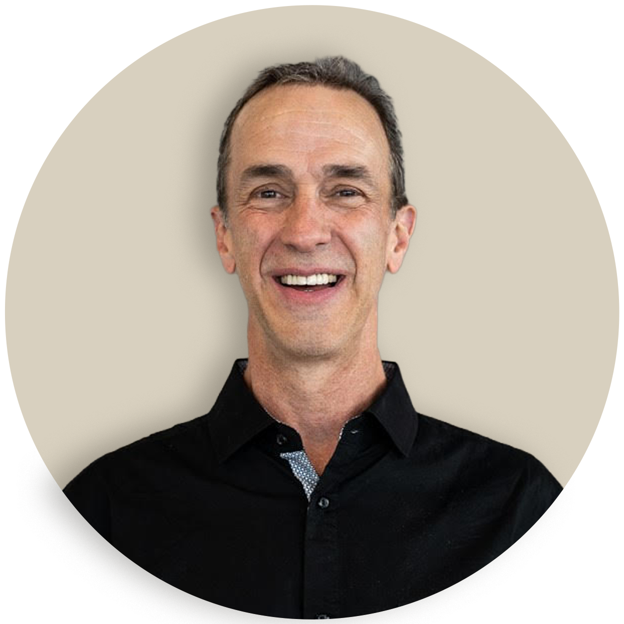 Portrait of Derek Voorhees in a black shirt on a beige background