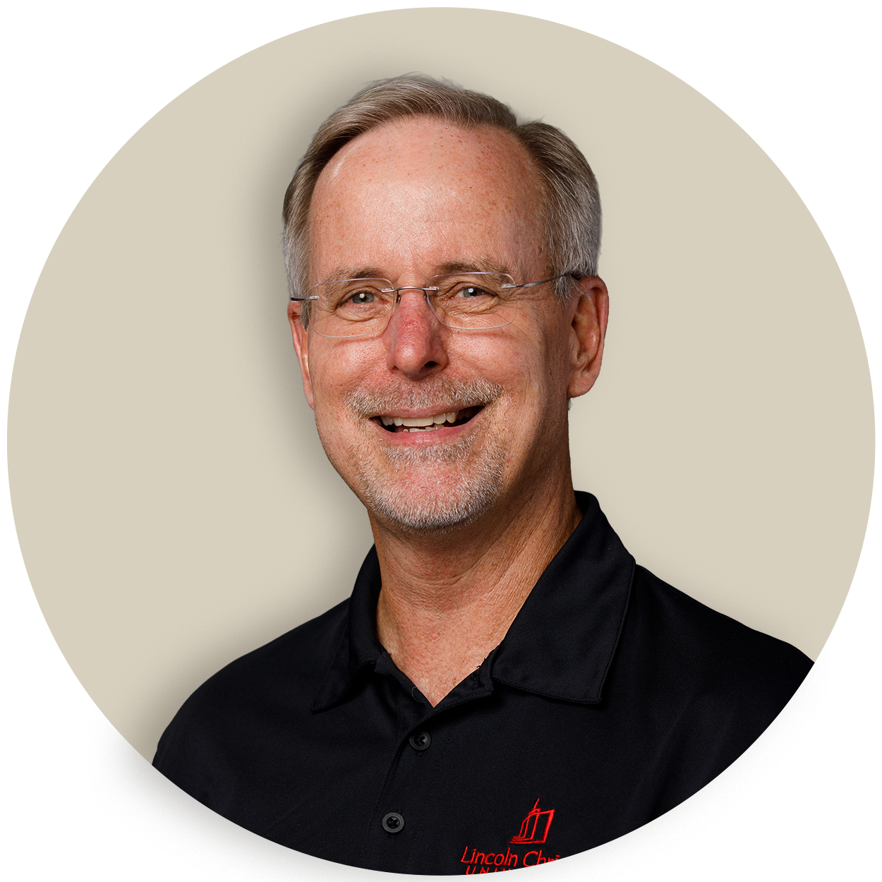 Portrait of Fred Johnson wearing glasses and a black polo shirt