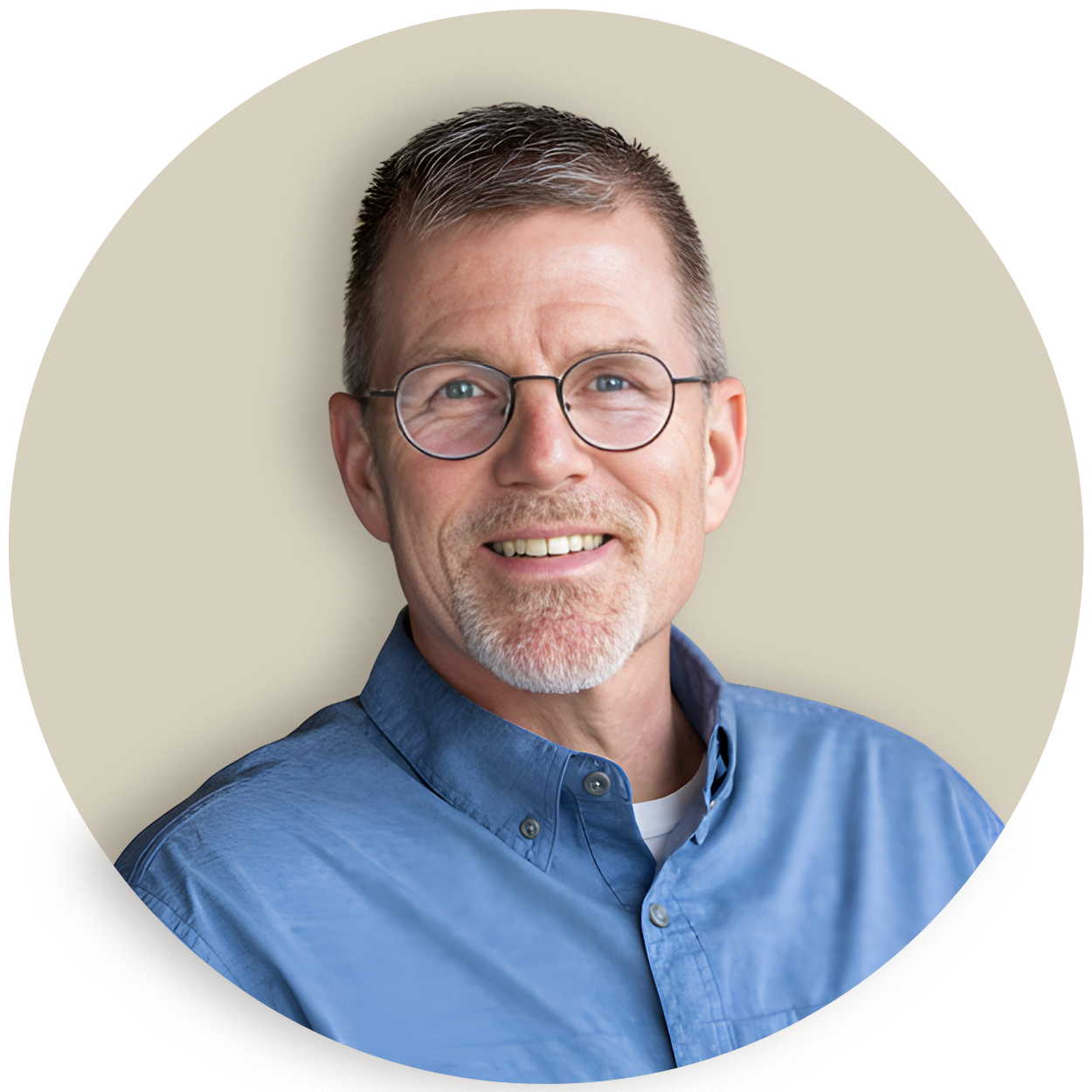 Portrait of Greg Taylor wearing glasses and a blue shirt