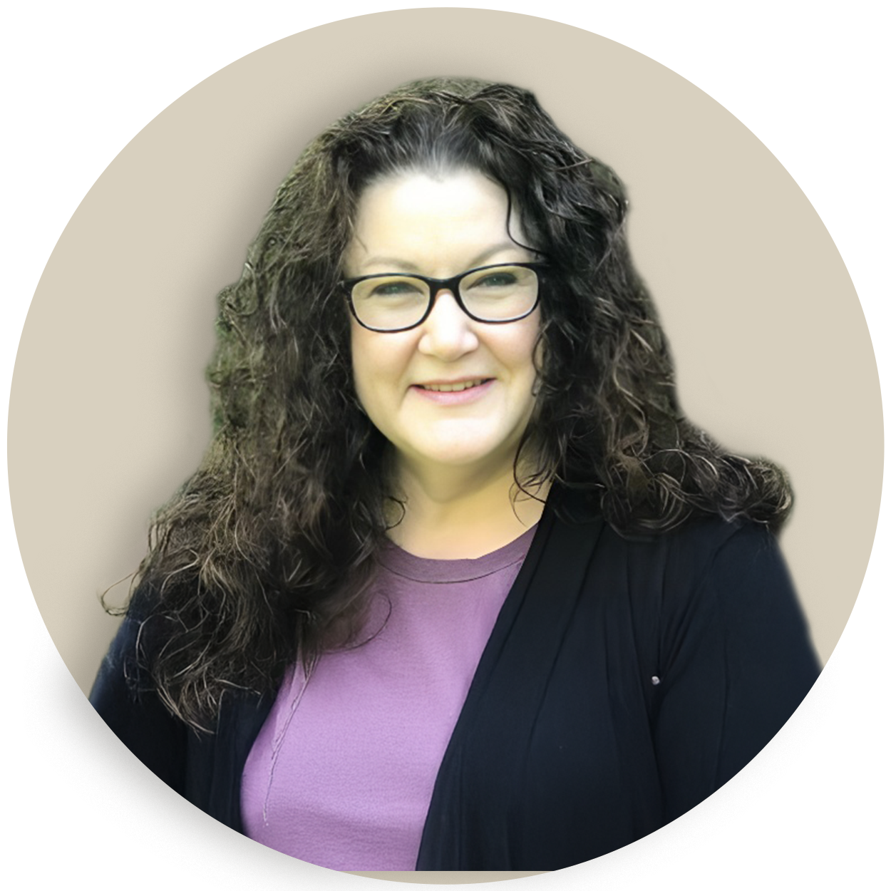Portrait of Jennifer Love with curly dark hair and glasses, wearing a purple top and black cardigan