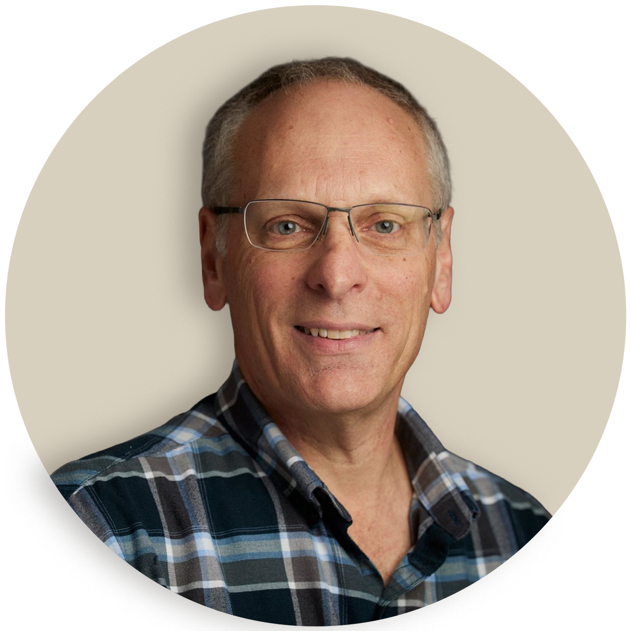 Portrait of Mark Mangano wearing glasses and a plaid shirt
