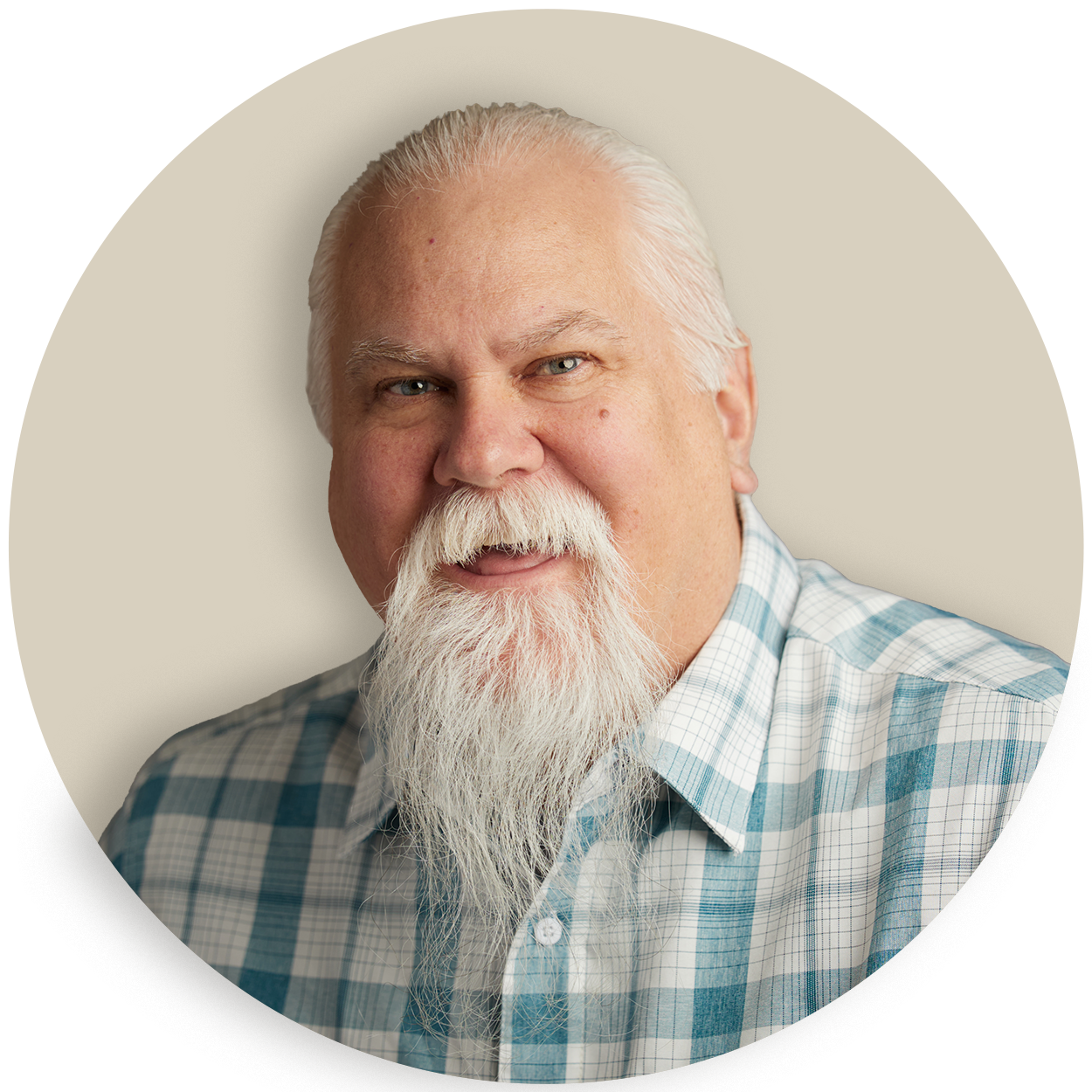 Portrait of Rondel Ramsey with white hair and a long white beard in a plaid shirt
