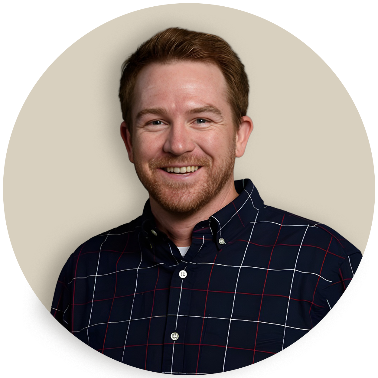 Portrait of Tyler Stewart in a dark plaid shirt on a beige background