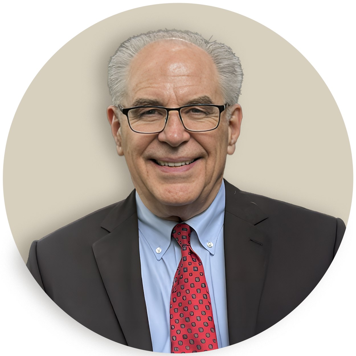 Portrait of Warren Knowles in a suit, glasses, and red tie, smiling at the camera
